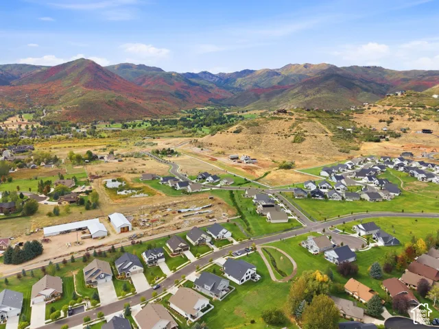 Established residential community featuring paved roads, green spaces, and mountain scenery