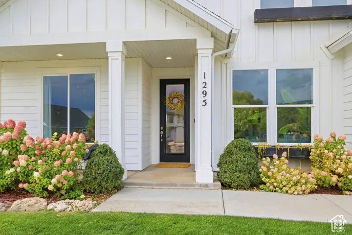 White board and batten siding with contrasting dark trim accents