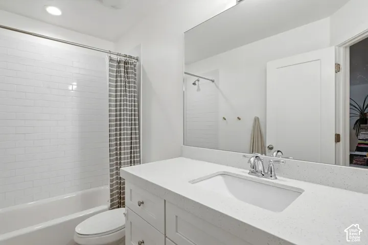 Built-in vanity with an integrated sink, polished chrome faucet, and expansive wall-mounted mirror