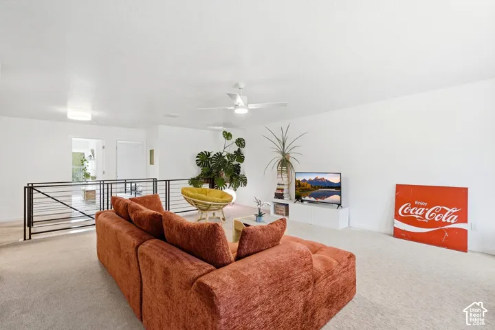 Spacious upper-level area with high ceilings, recessed lighting, and a ceiling fan