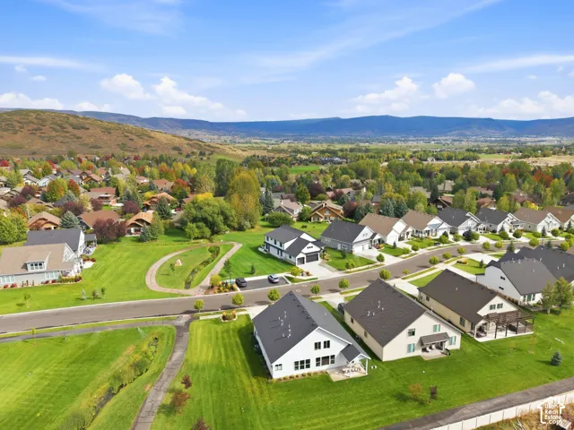 Neighborhood setting with residences featuring varied architectural styles and mature landscaping