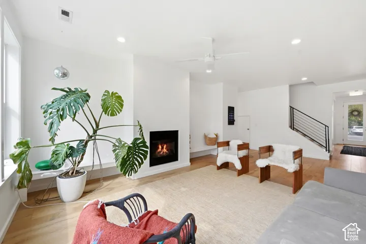 Hardwood-finish flooring, recessed lighting, and a modern fireplace
