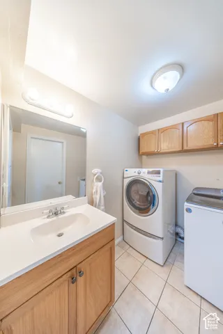 Vanity with wood-finish cabinetry, integrated sink, and chrome-finish fixtures