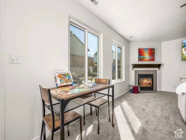 Fireplace with tile surround, wood mantel, and hearth