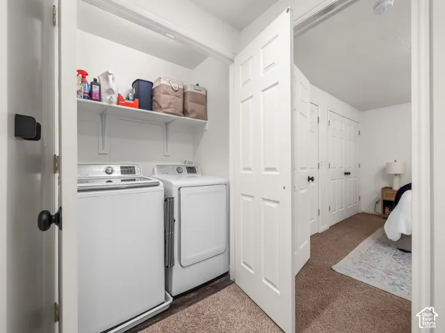 Laundry area featuring white built-in shelving and white paneled doors