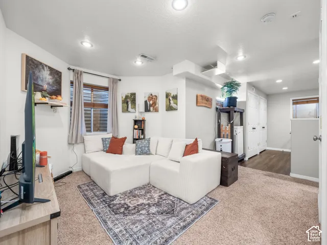 Recessed lighting, wood-finish flooring, two-panel closet doors, and window with blinds