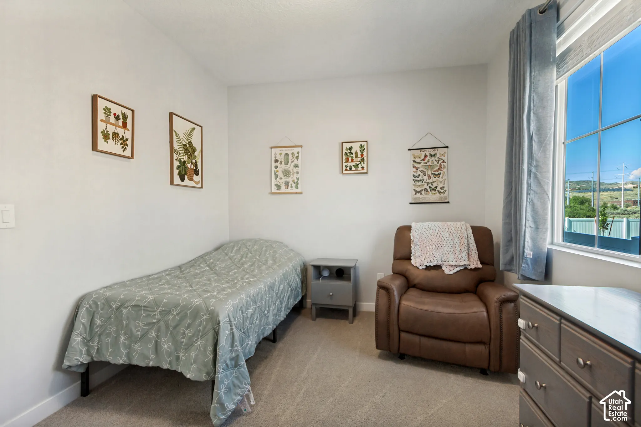 Wall-to-wall carpeting and a large window with ample natural light