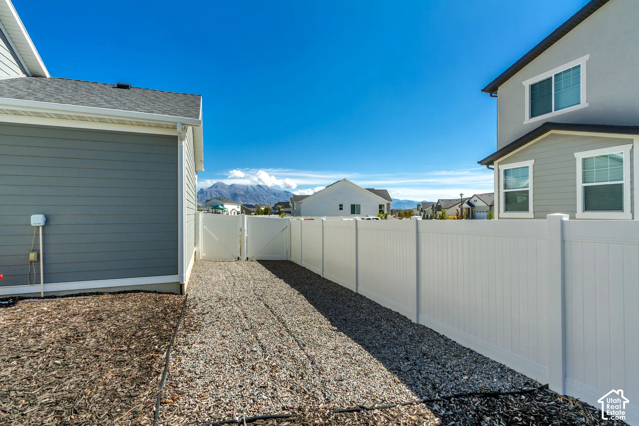 White vinyl fencing enclosing a gravel pathway