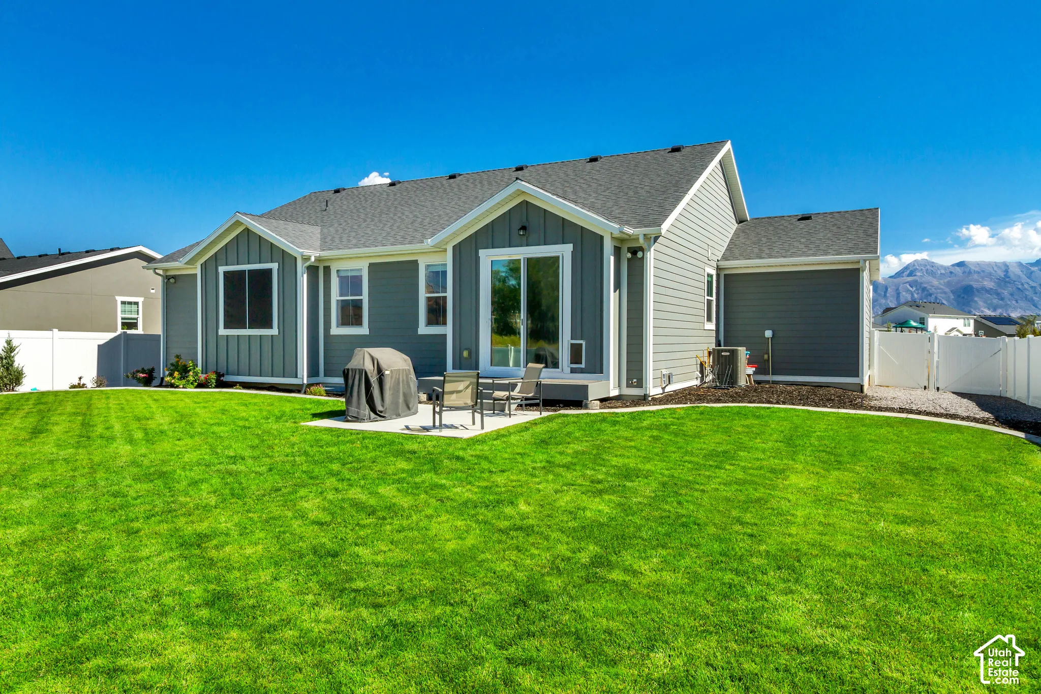Expansive manicured lawn with a concrete patio