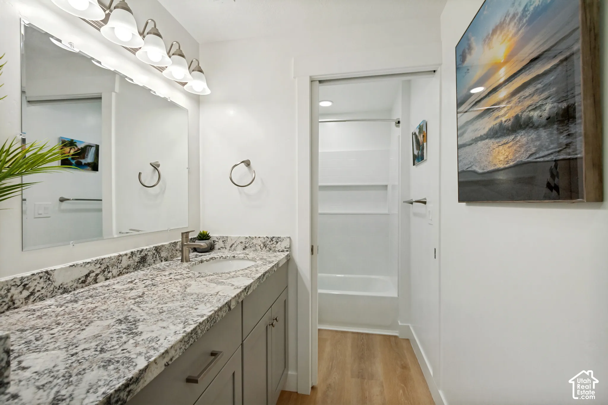 Double vanity featuring a light-toned granite countertop, undermount sinks, and brushed nickel faucets