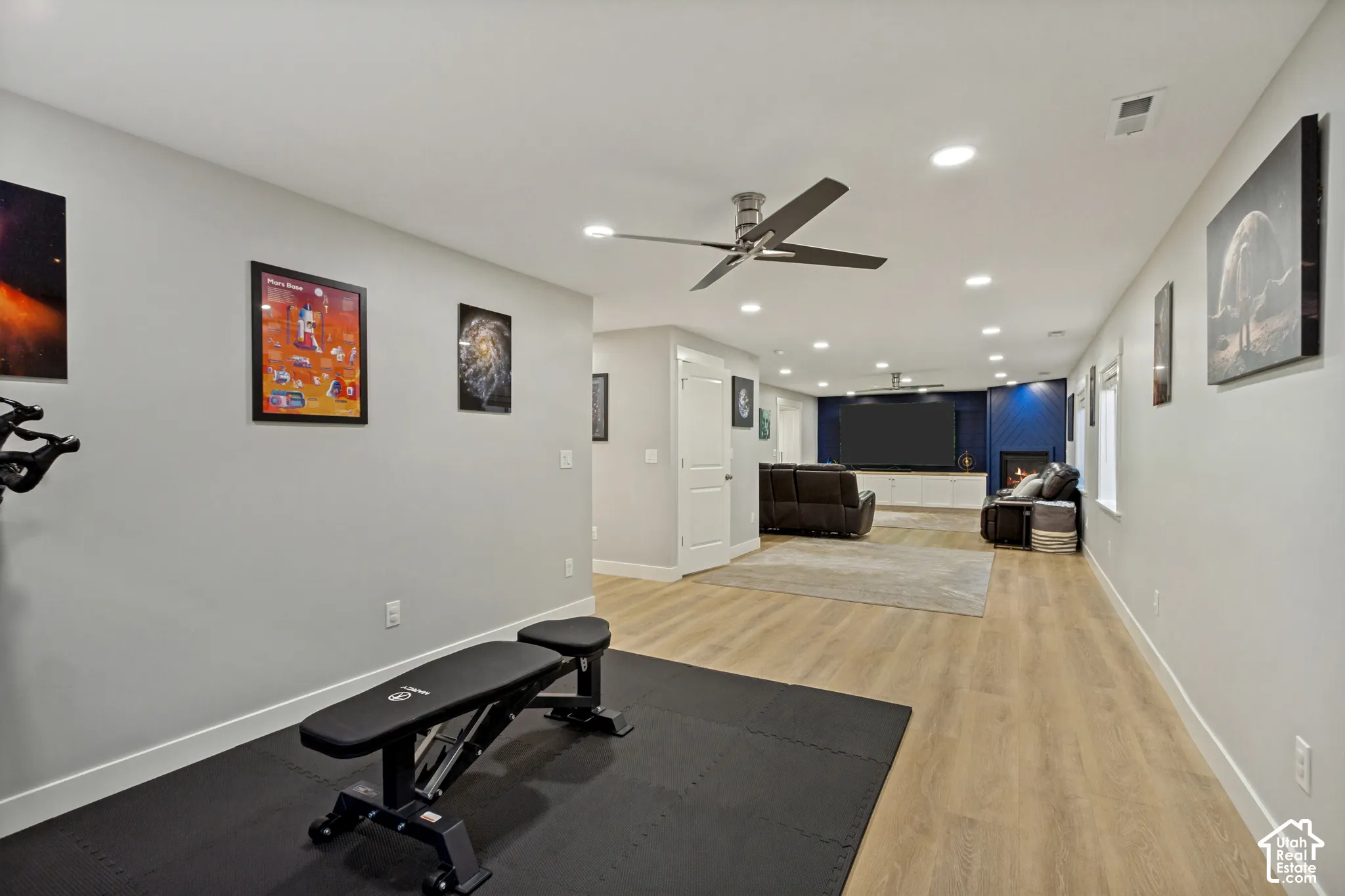 Spacious recreation area featuring LVP flooring and recessed lighting