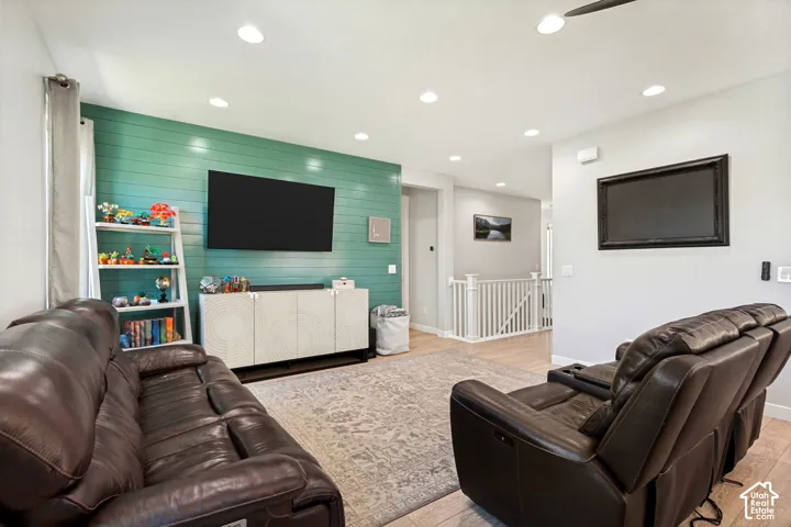 Recessed lighting throughout, LVP flooring, and a decorative shiplap accent wall
