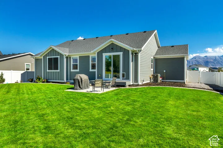 Expansive manicured lawn with a concrete patio