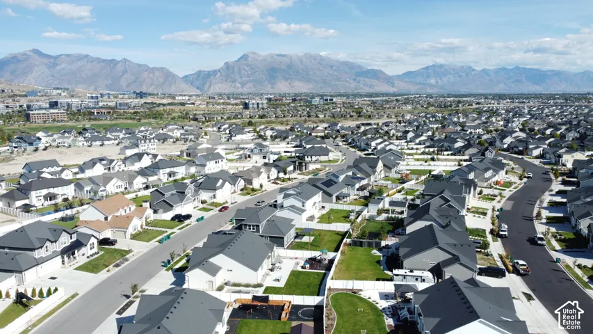 Expansive suburban development featuring numerous single-family homes with dark roofs and light exteriors