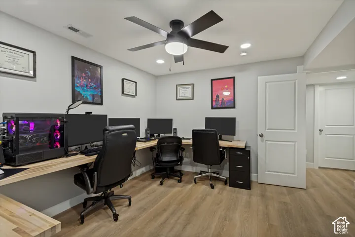 Spacious interior with neutral wall tones, LVP flooring, recessed lighting, a ceiling fan, and white panel doors