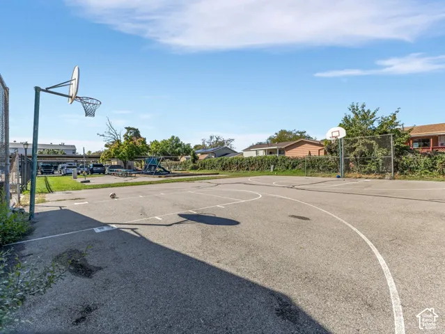 Asphalt sports court featuring two basketball hoops