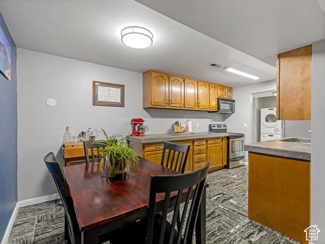 Kitchen featuring wood cabinetry, stainless steel appliances, and patterned flooring