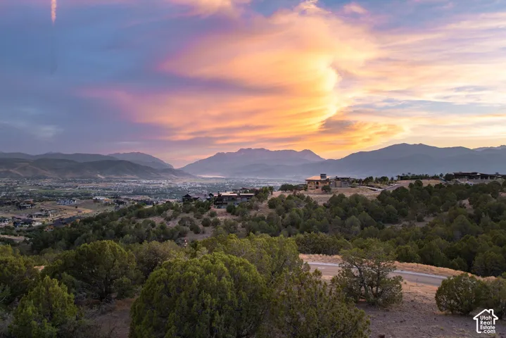 Expansive mountain and city vistas with a prominent mountain range backdrop