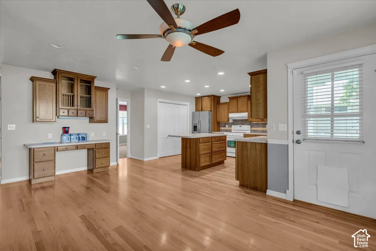 Wood-finish flooring throughout, with a ceiling fan