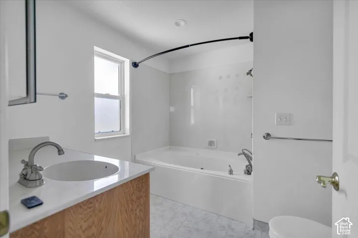 Primary Bathroom White vanity with a built-in sink and chrome faucet
