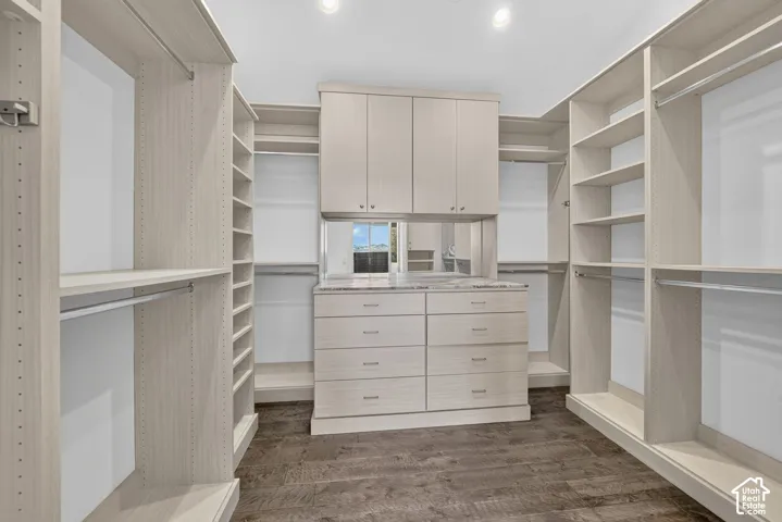 Custom closet system featuring built-in cabinetry, shelving, and drawers