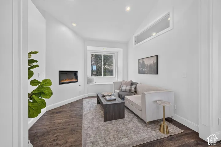Recessed lighting, wood-finish flooring, built-in fireplace, transom window, and a window seat