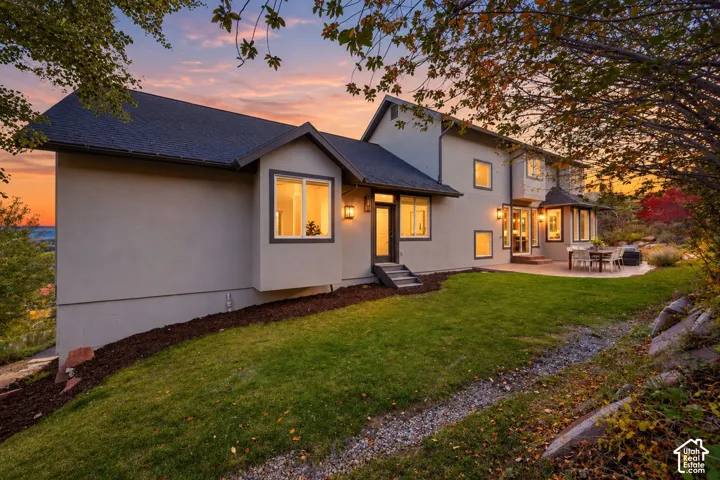 Multi-level stucco exterior with a dark shingle roof
