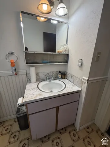 Vanity with integrated sink, chrome faucet, and under-cabinet storage