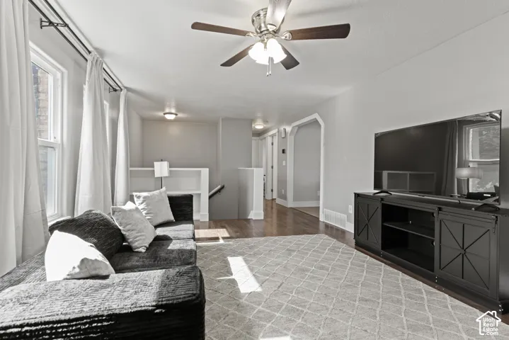 Hardwood-finish flooring, recessed lighting, ceiling fan light fixture, and arched doorway