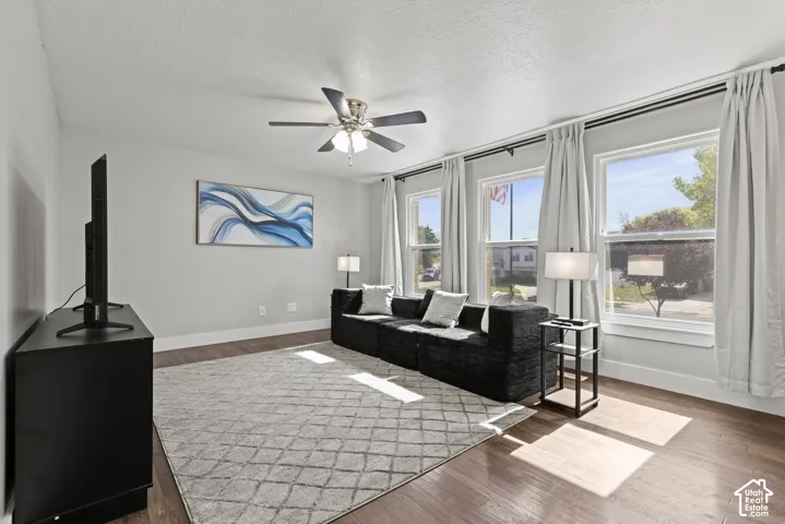 Recessed lighting, wood-finish flooring, ceiling fan, and multiple windows with white trim