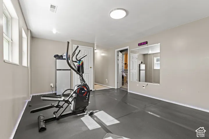 Recessed lighting, flush-mount ceiling light, light gray wall paint, and multiple windows