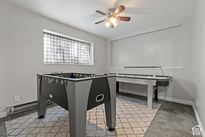 Recessed window, ceiling fan with integrated lighting, wall-to-wall carpeting, and neutral wall tones