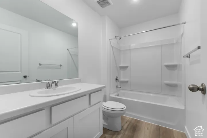 White vanity with an integrated sink, polished chrome faucet, and expansive mirror