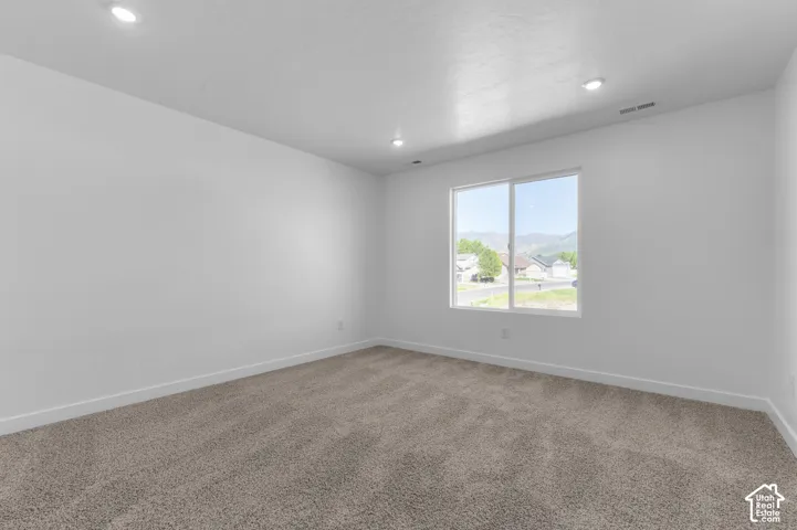 Neutral-toned carpet flooring and white painted walls create a versatile interior