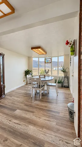 Wood-finish flooring, recessed lighting, and a bay window