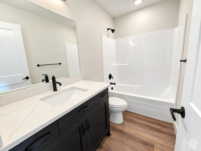 Black vanity with white countertop, undermount sink, and black faucet