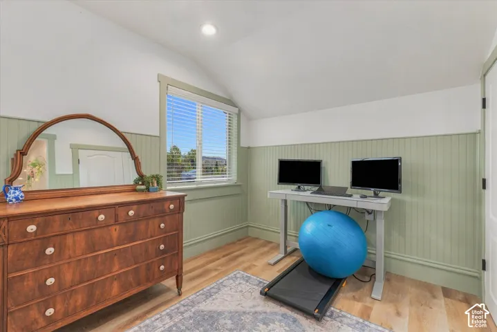 Wood-finish flooring, beadboard wainscoting, recessed lighting, and a window with blinds