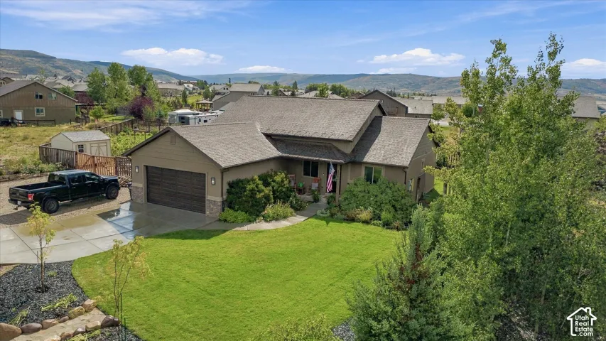 Single-story exterior with a two-car garage and concrete driveway