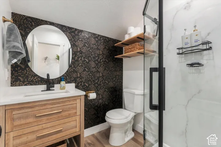 Wood-finish vanity with white countertop and black single-handle faucet