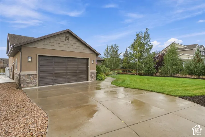 Attached two-car garage with a brown panel door