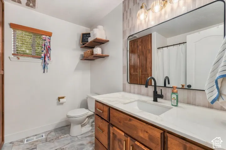 Wood-finish vanity with a white countertop and integrated rectangular sink