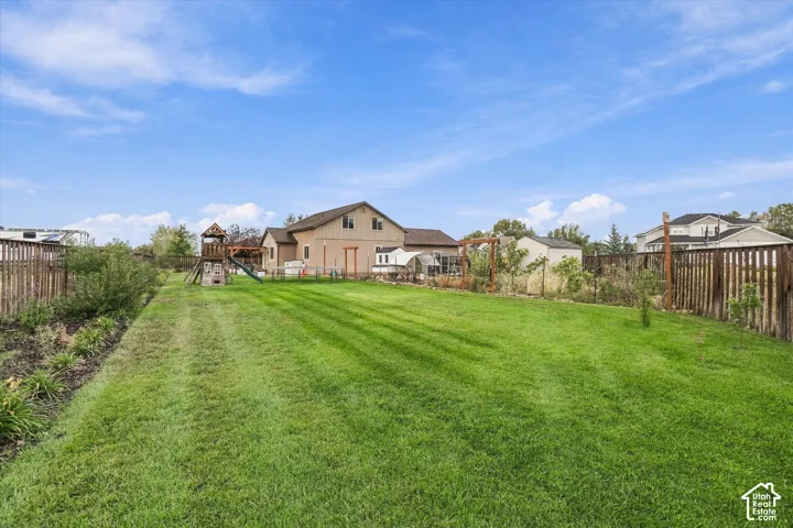Expansive grass lawn with perimeter fencing