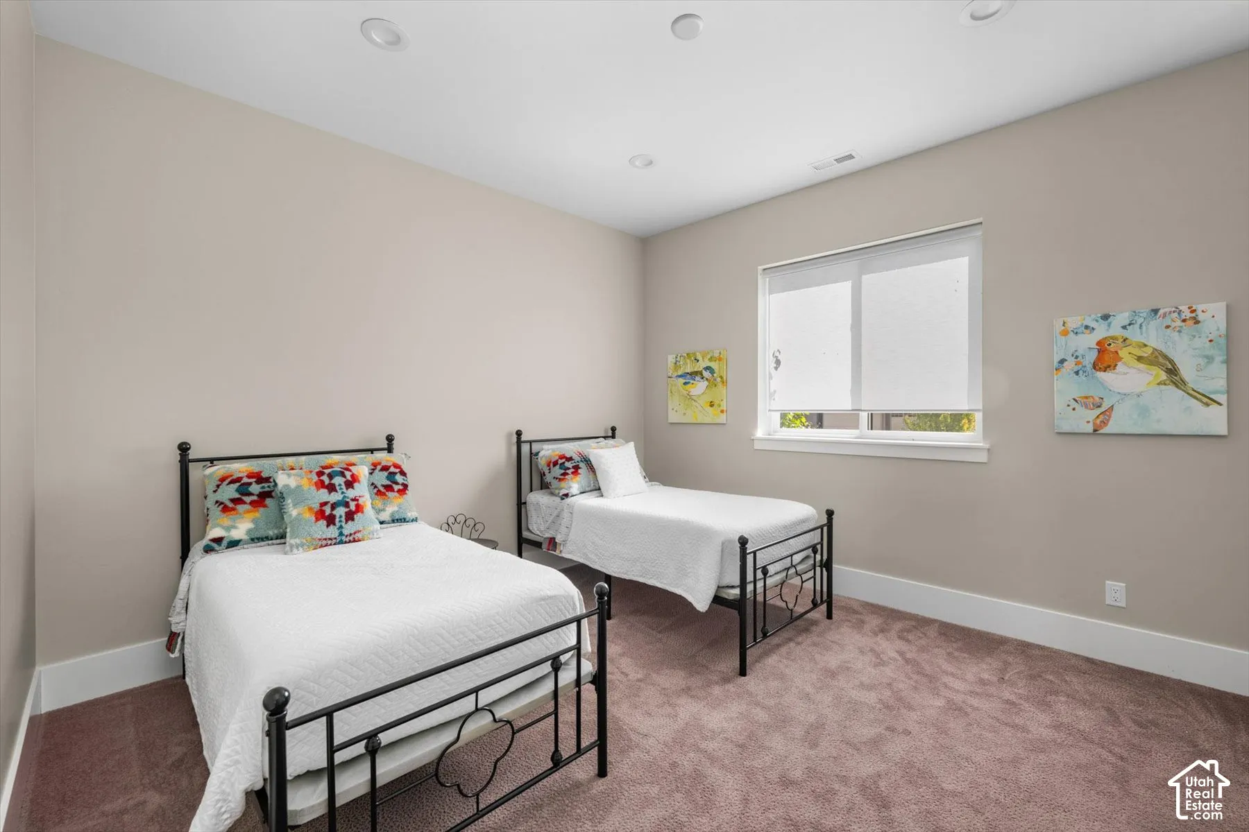 Recessed lighting, neutral wall paint, window with roller shades, and carpeted flooring