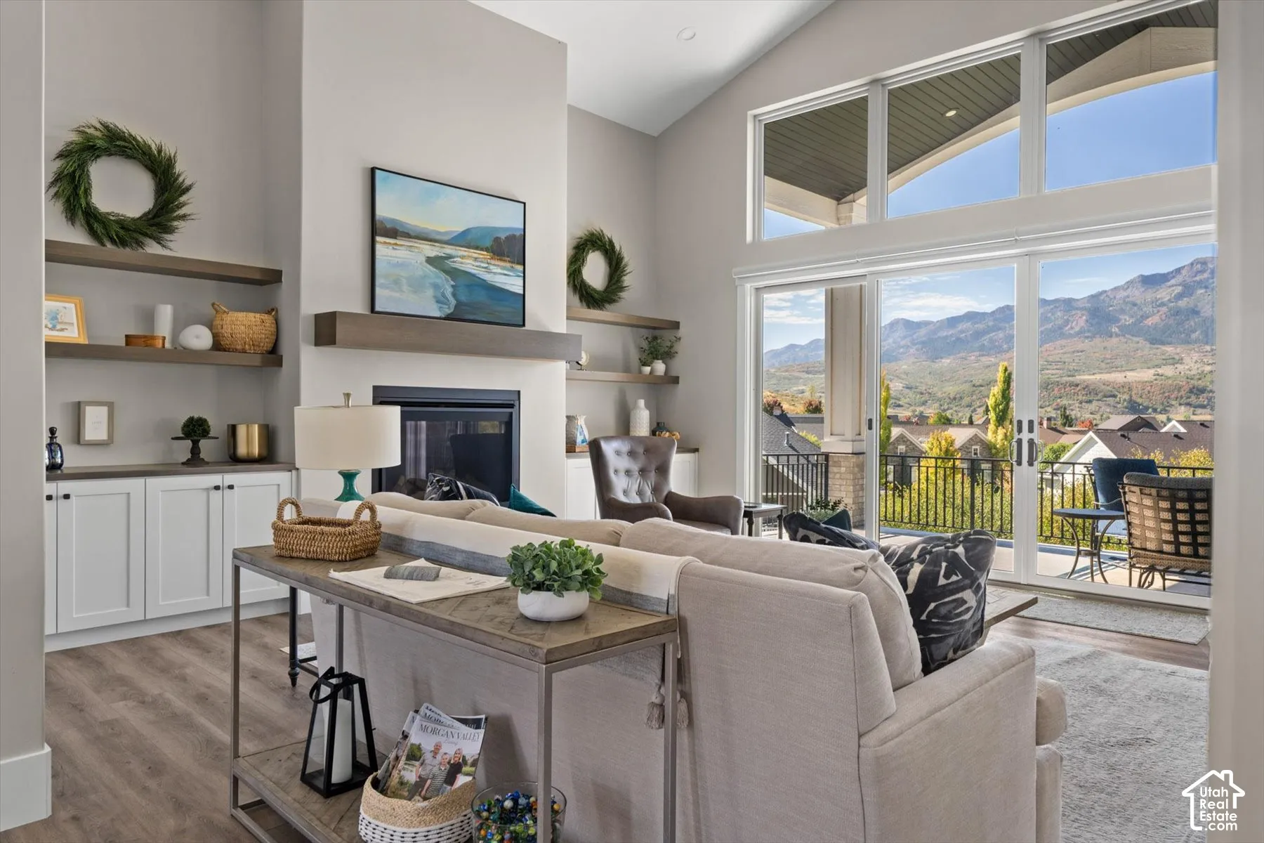 Vaulted ceilings, a built-in fireplace, and custom shelving with lower cabinetry