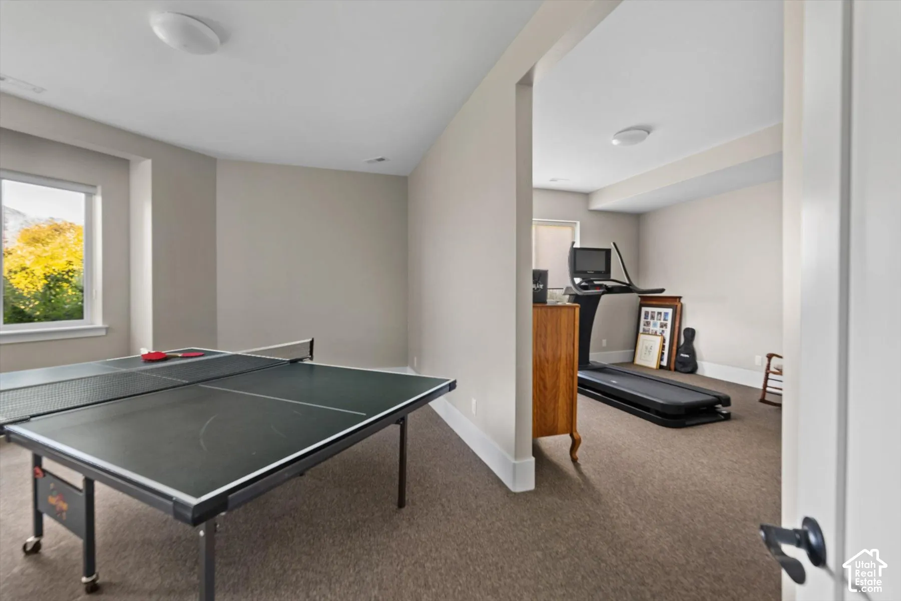 Spacious room with light neutral wall tones, recessed window, and carpeted flooring