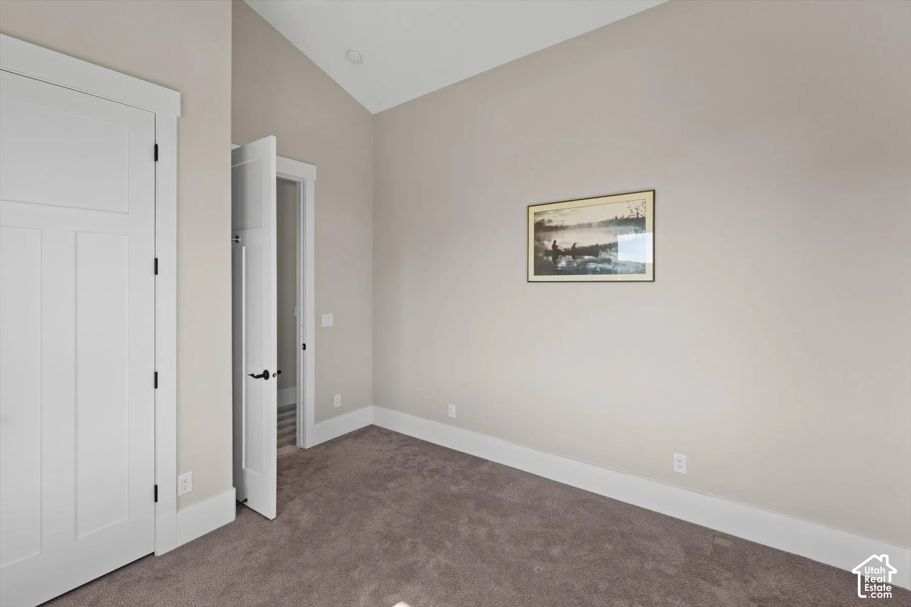 Vaulted ceiling with recessed lighting, light-toned wall paint, and gray carpet flooring