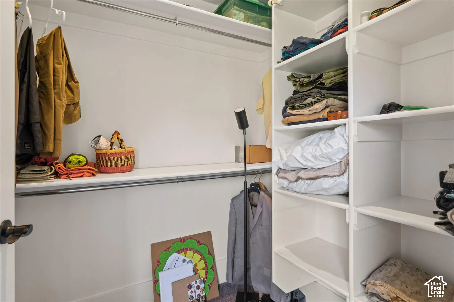 Built-in closet shelving, hanging rods, and an overhead shelf provide storage solutions