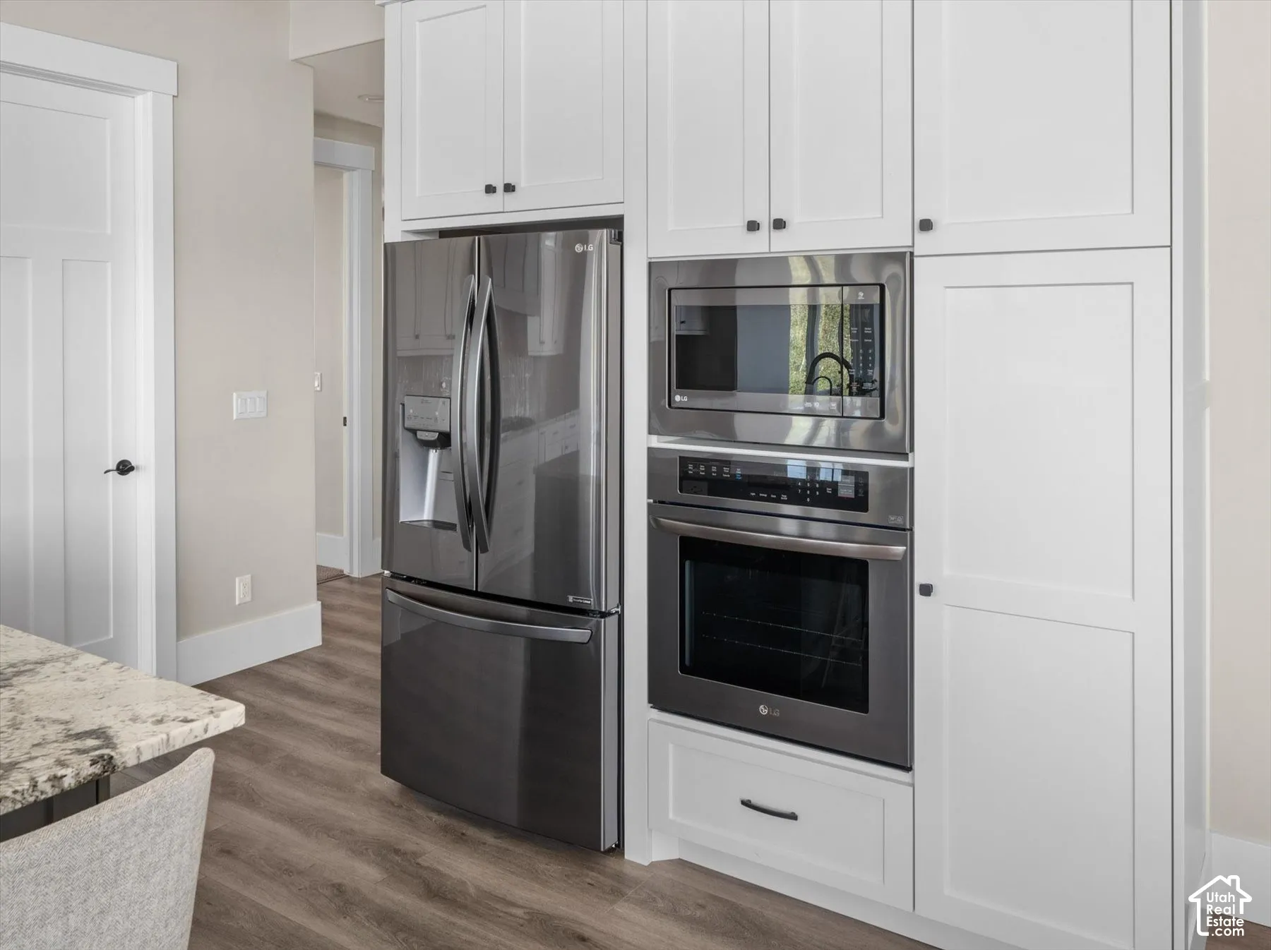 White shaker-style cabinetry with matte black hardware