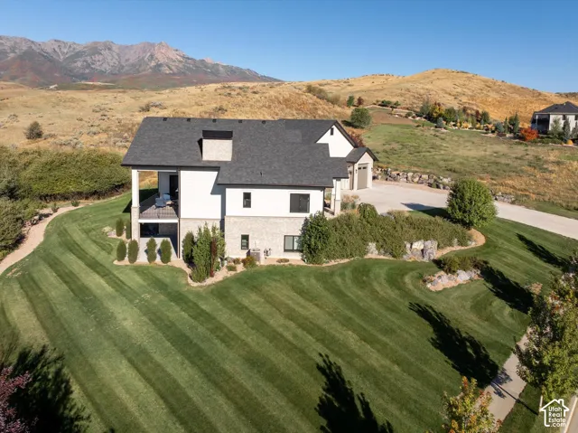 Contemporary two-story residence with a multi-level stone and siding exterior