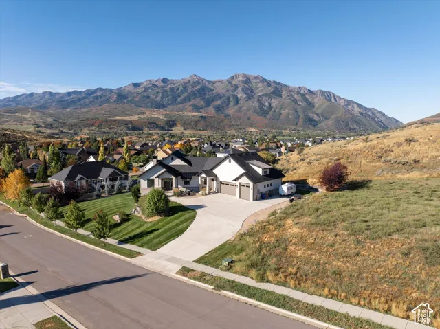 Contemporary single-story residence with an attached three-car garage, concrete driveway, and manicured front lawn